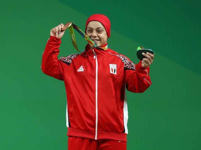 Sara Ahmed of Egypt holds up her bronze medal
