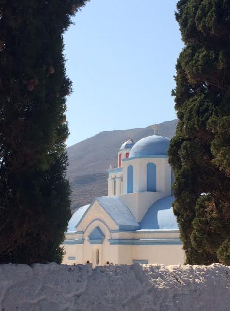 The pretty church is is one of few blue and white buildings on the island