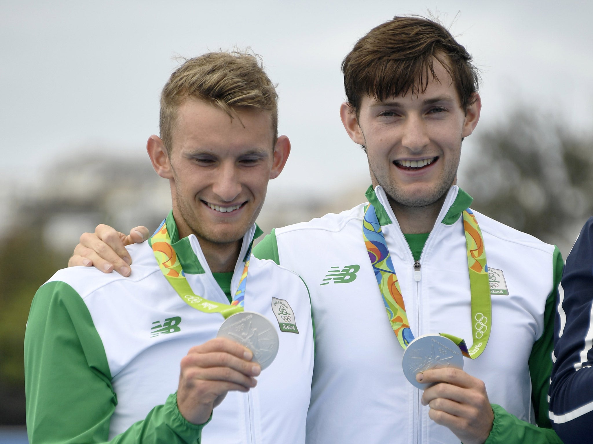 Gary and Paul O'Donovan celebrate with their silver medals