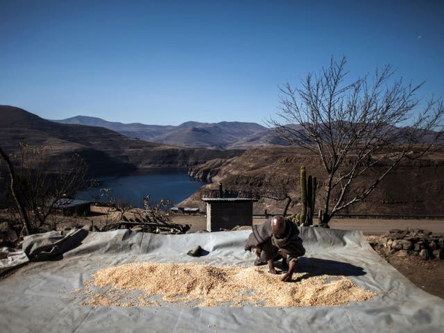 Mohlakoana Molise, 65, sorts through his last yield for the year in front of the controversial Katse dam on July 13, 2016 in Katse.