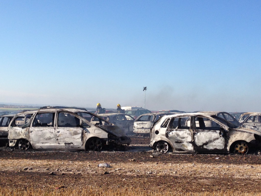Burnt cars in the car park at BoomTown Fair near Winchester in Hampshire