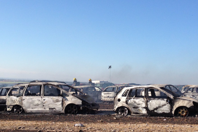 Burnt cars in the car park at BoomTown Fair near Winchester in Hampshire