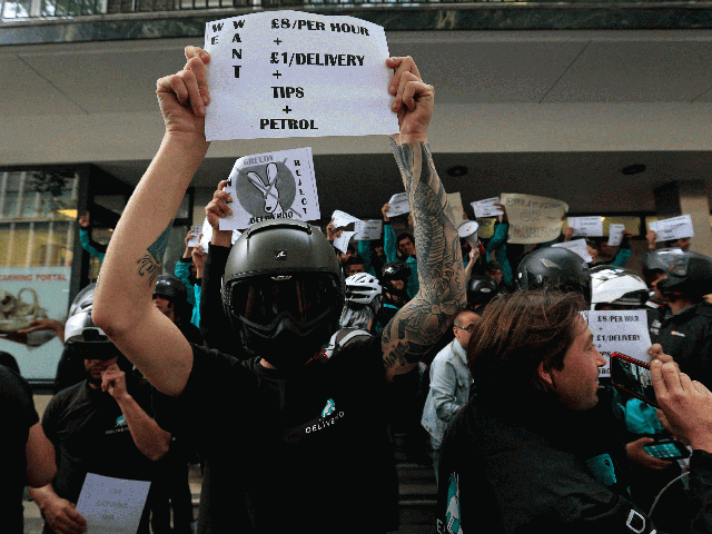 Deliveroo riders hold a protest over pay outside the company HQ in London on Thursday