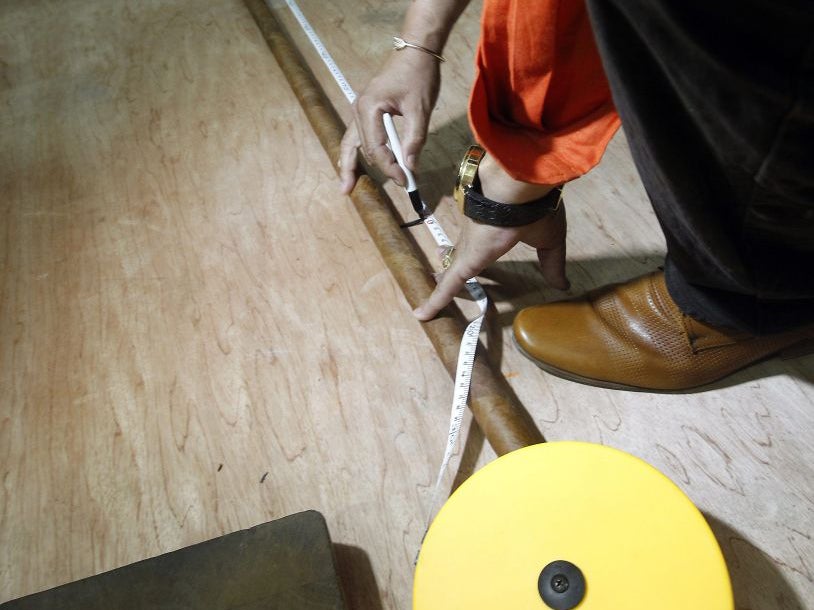 The world's longest cigar rolled up by Cuban Jose Castelar Cairo, known as 'Cueto', is measured in Havana, Cuba