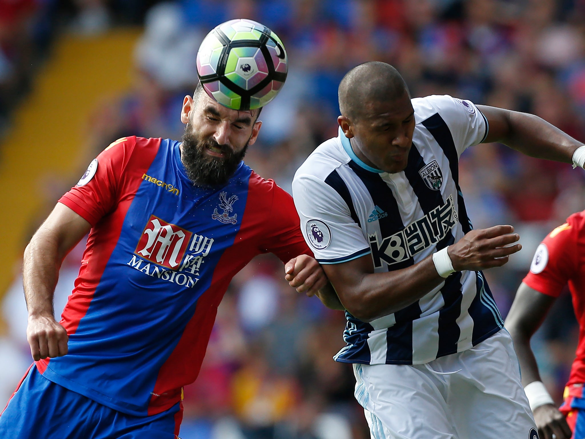 Rondon battles for the ball with Mile Jedinak