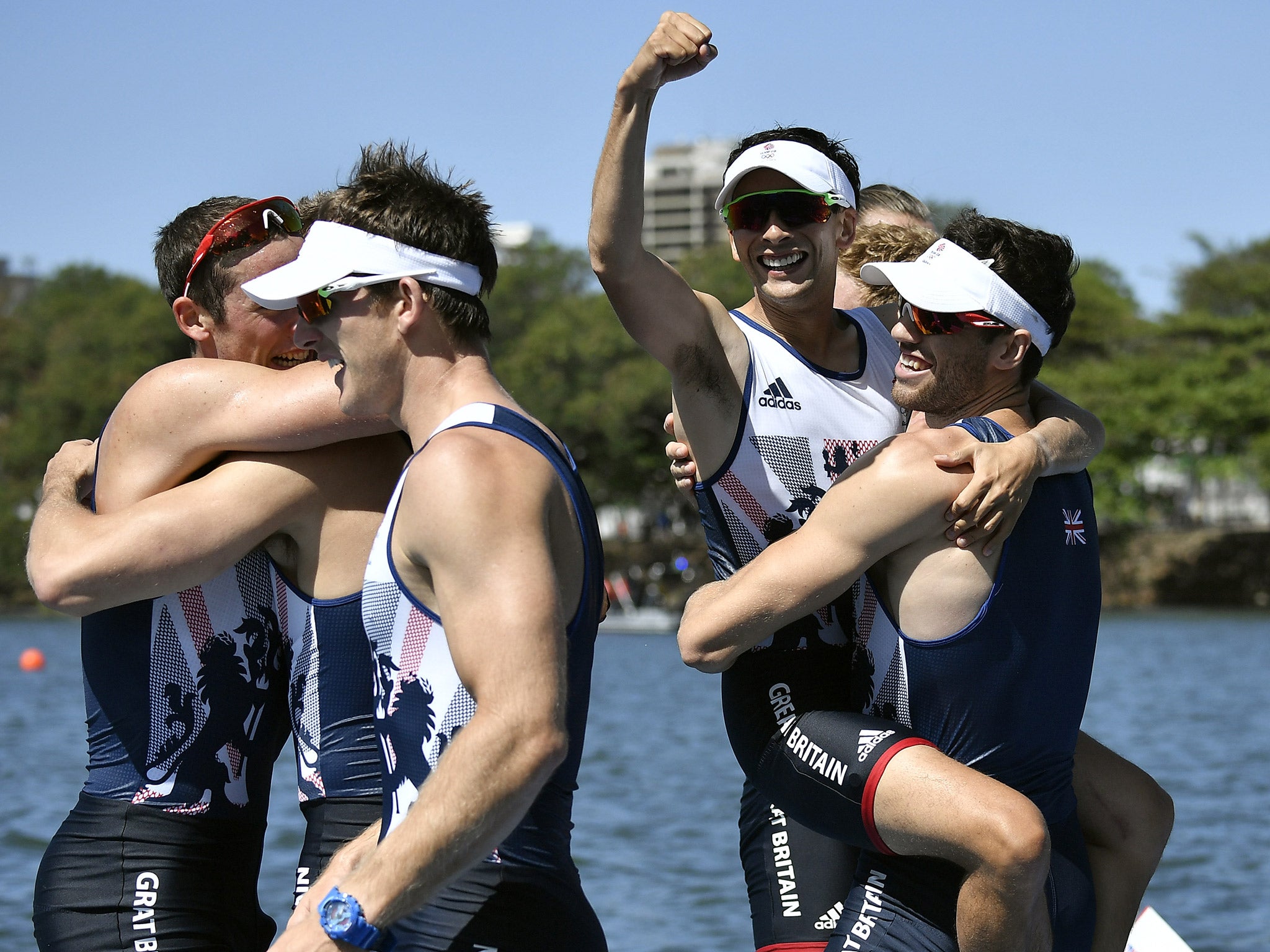 Members of Team GB's men's eight rowing team celebrate their gold medal success at Rio 2016