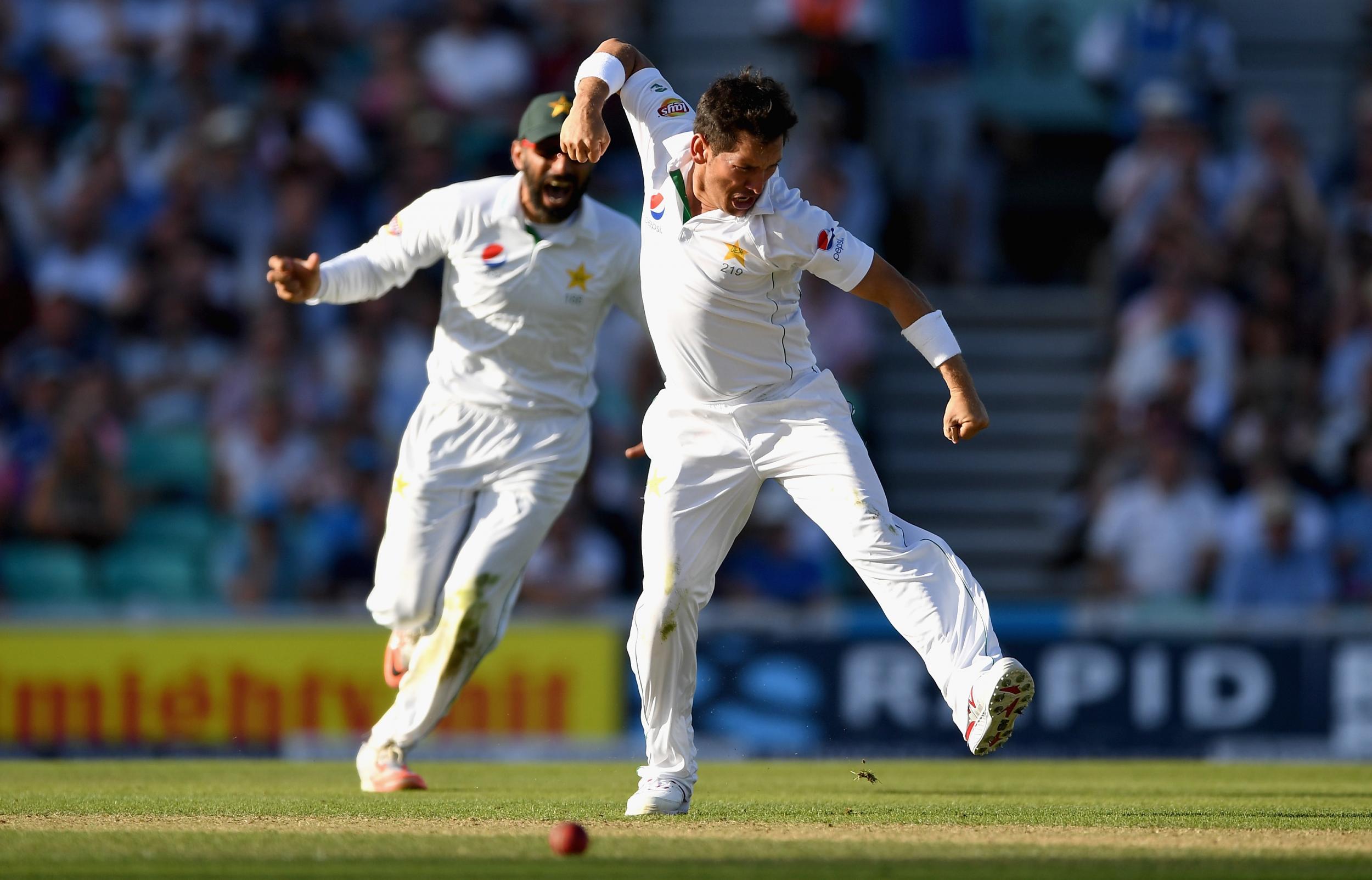 Yasir Shah of Pakistan celebrates with Pakistan captain Misbah-ul-Haq after dismissing Joe Root of England