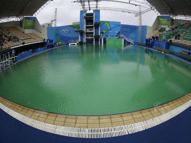 The water of the diving pool appears a murky green in the Maria Lenk Aquatic Center