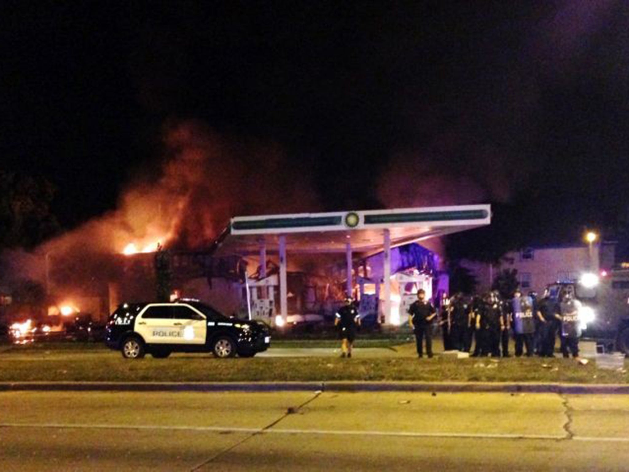 A burning petrol station in Milwaukee as over 100 people take to the streets to protest another police killing