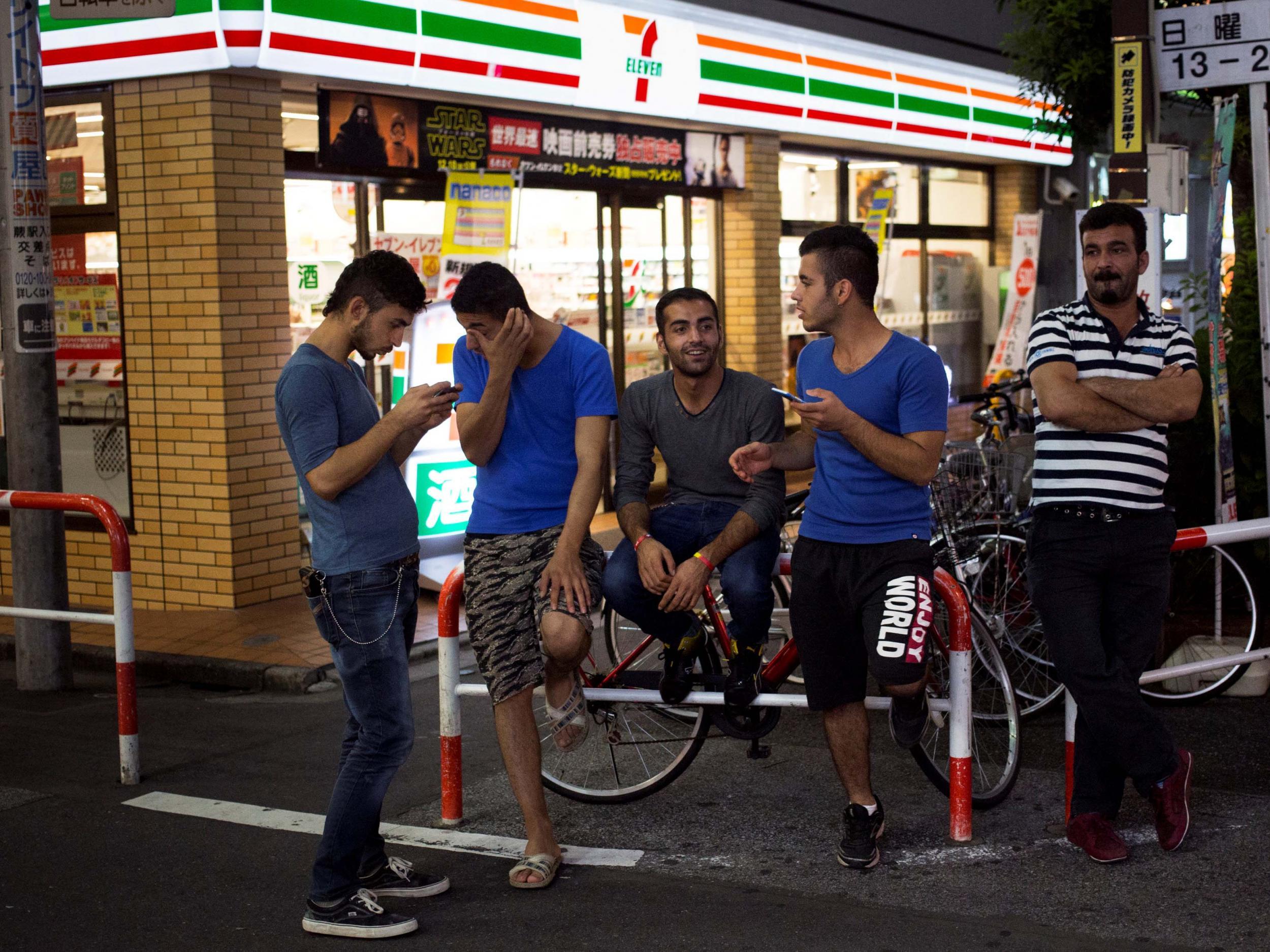 Kurdish men mingle outside a convenience store in Japan