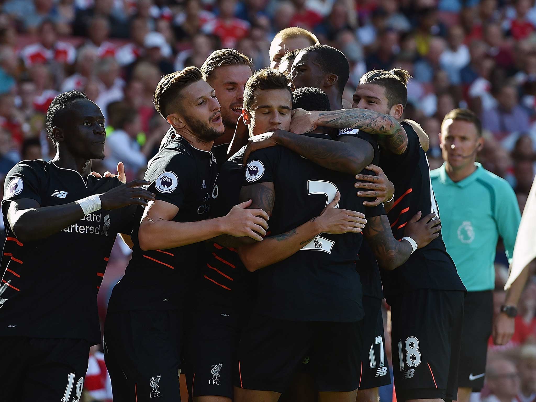 Philippe Coutinho is mobbed by his Liverpool team-mates