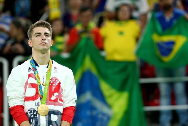 Gold medalist Max Whitlock of Great Britain stands on the podium at the medal ceremony for Men's Floor Exercise