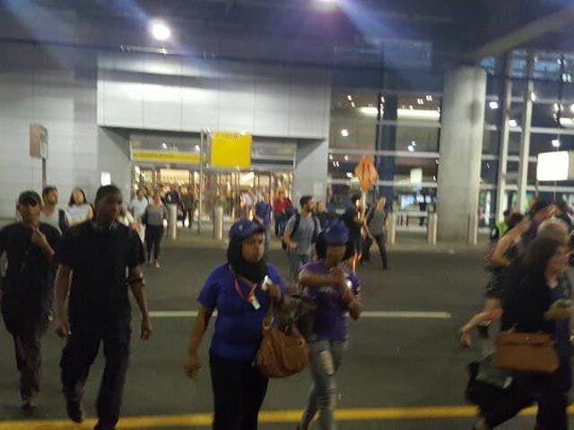 Travelers evacuate Terminal 8 at JFK International Airport after reports of shots fired <em>Robbie Rob/Twitter</em>