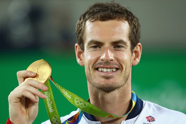 Andy Murray celebrates with his gold medal after winning the men's Olympic tennis singles final