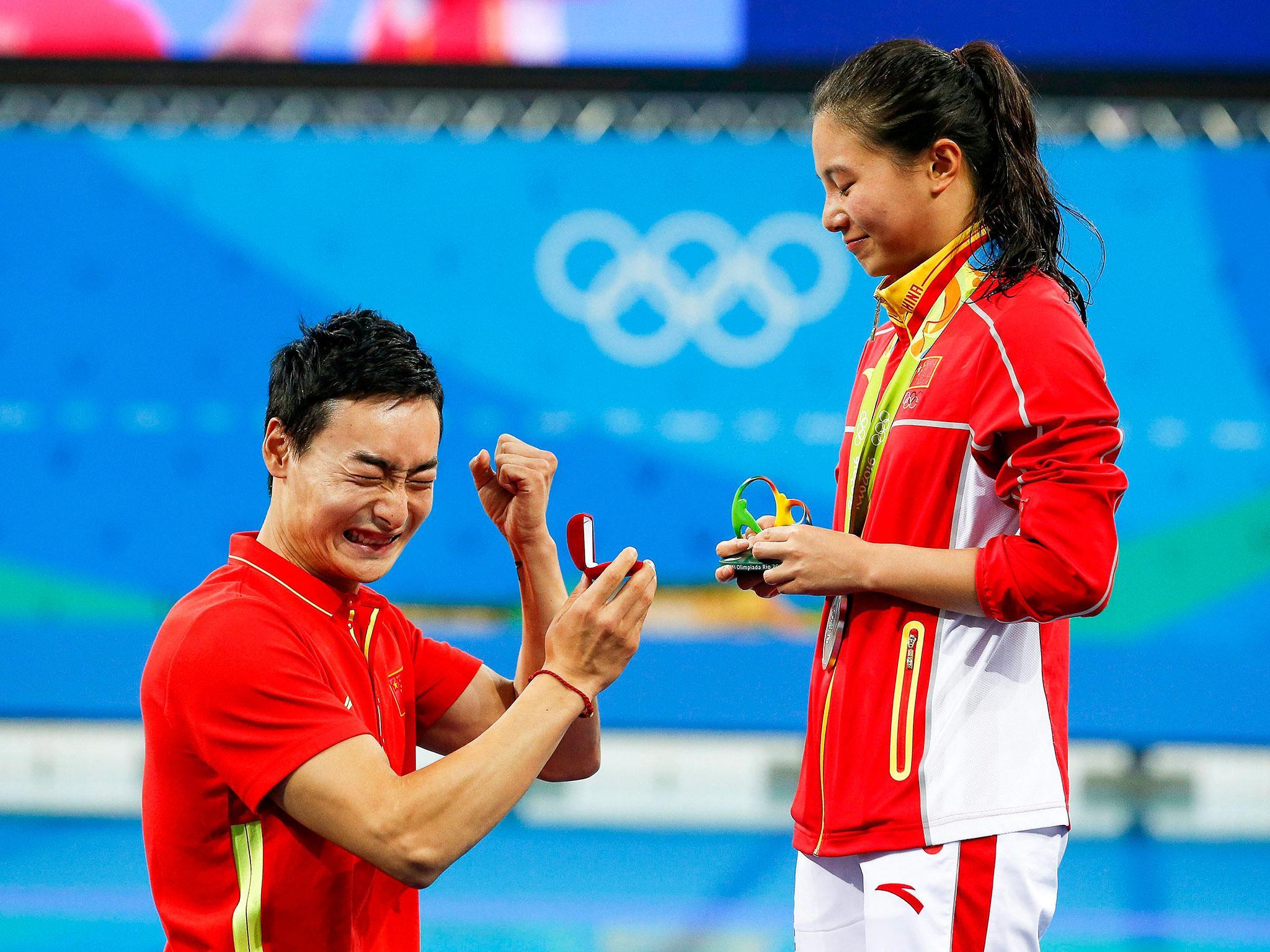 He Zi of China receives a marriage proposal from Chinese diver Qin Kai after winning the silver medal in the women's 3m Springboard Final at Rio