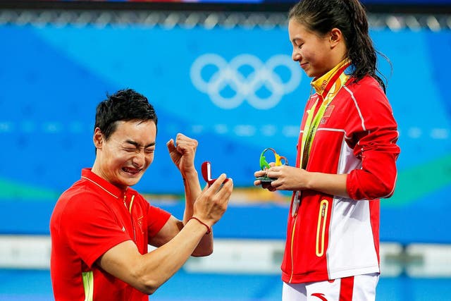 He Zi of China receives a marriage proposal from Chinese diver Ki Qin after winning the silver medal in the women's 3m Springboard final at Rio