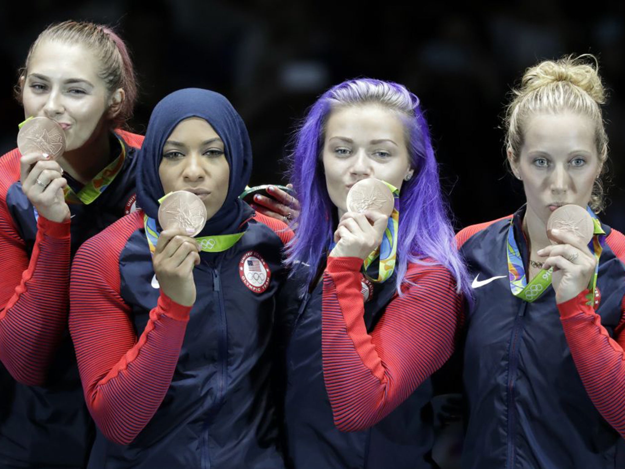 From left, Dagmara Wozniak, Ibtihaj Muhammad, Monica Aksamit and Mariel Zagunis of the United States