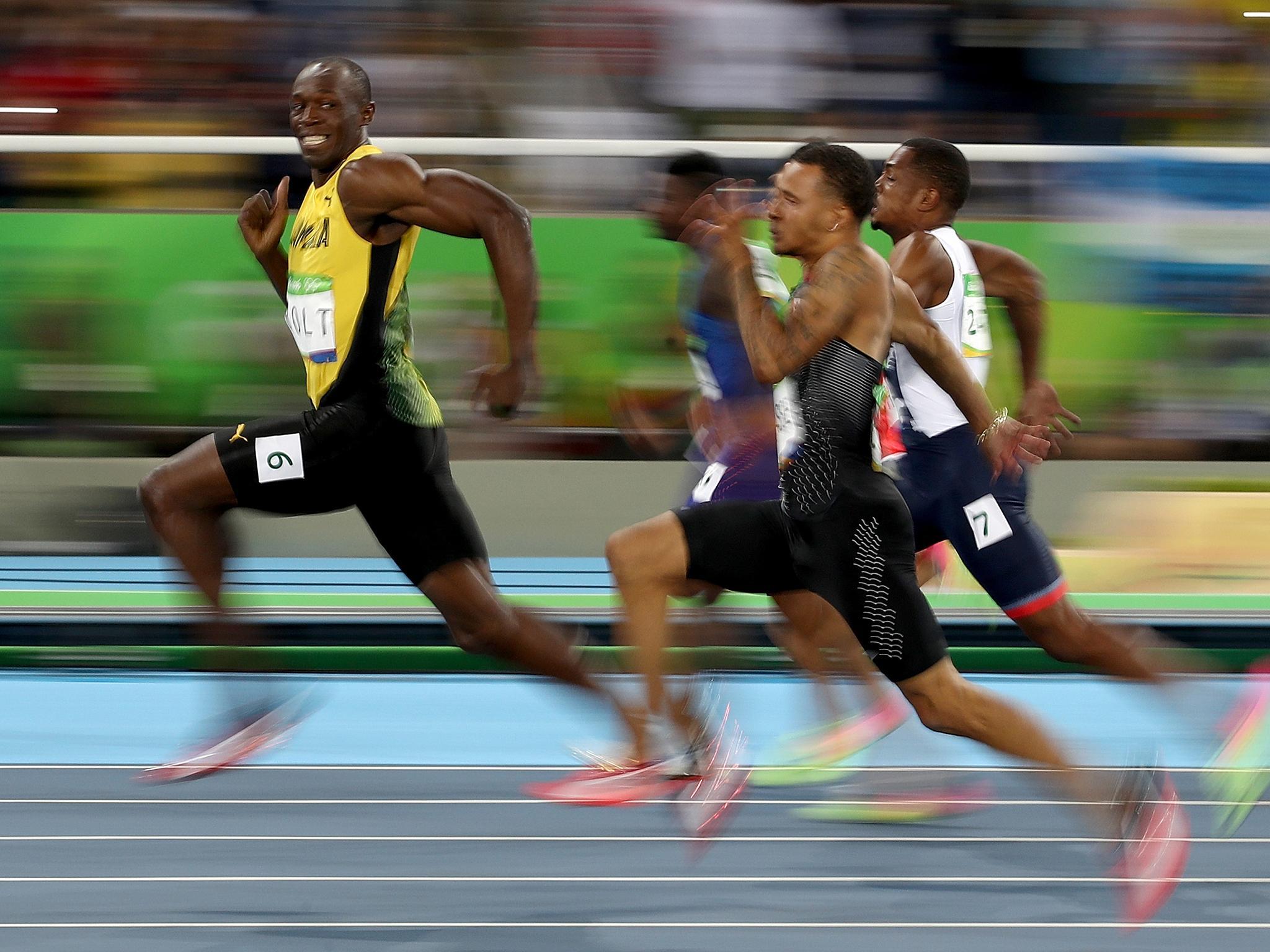 Usain Bolt smiling as he wins the 100 metre semi-final