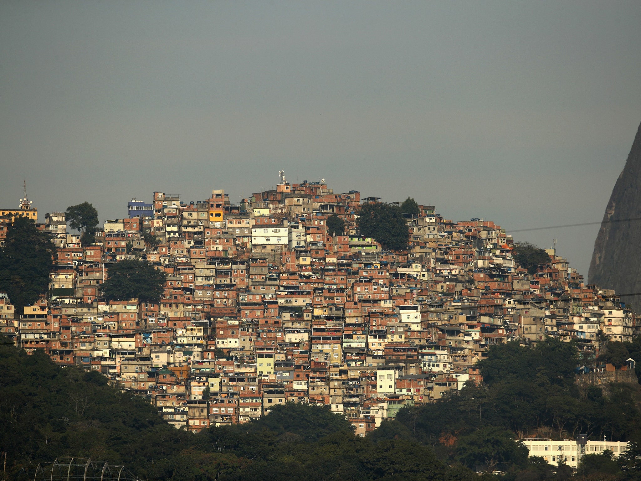 Beyond the Olympic village in Rio and the golden beaches lies a much darker monster