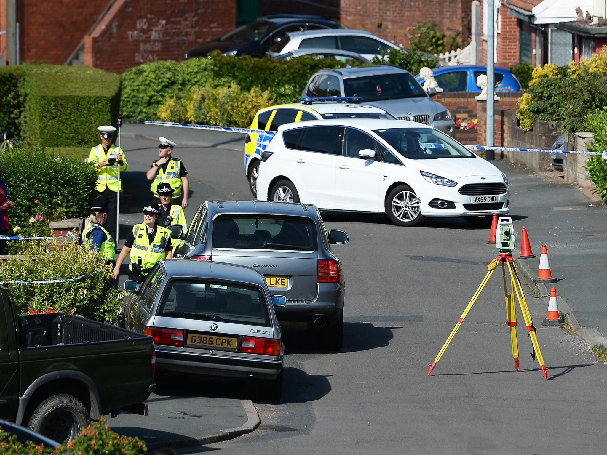 Police survey the scene in Meadow Close in the Trench area of Telford, where the former Aston Villa footballer died after he was tasered by police