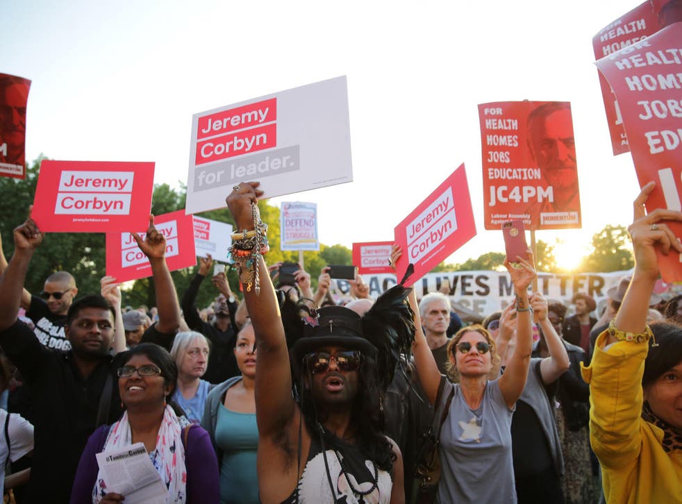 Supporters of Jeremy Corbyn hold up placards and cheer at a Black, Asian and minority ethnic rally in north London