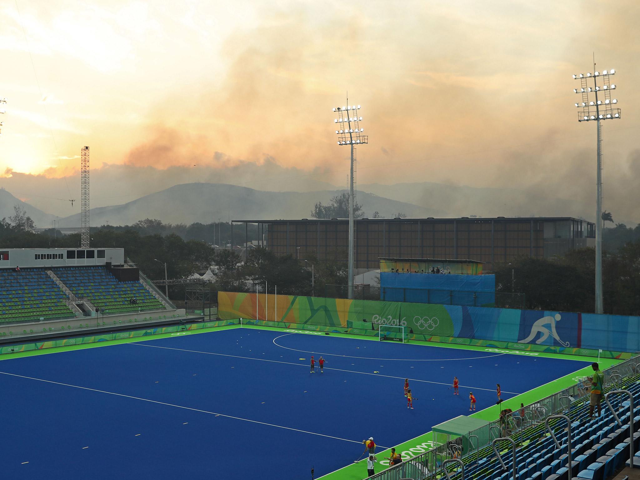 &#13;
Smoke rises from the forest fire behind the Deodoro hockey stadium &#13;