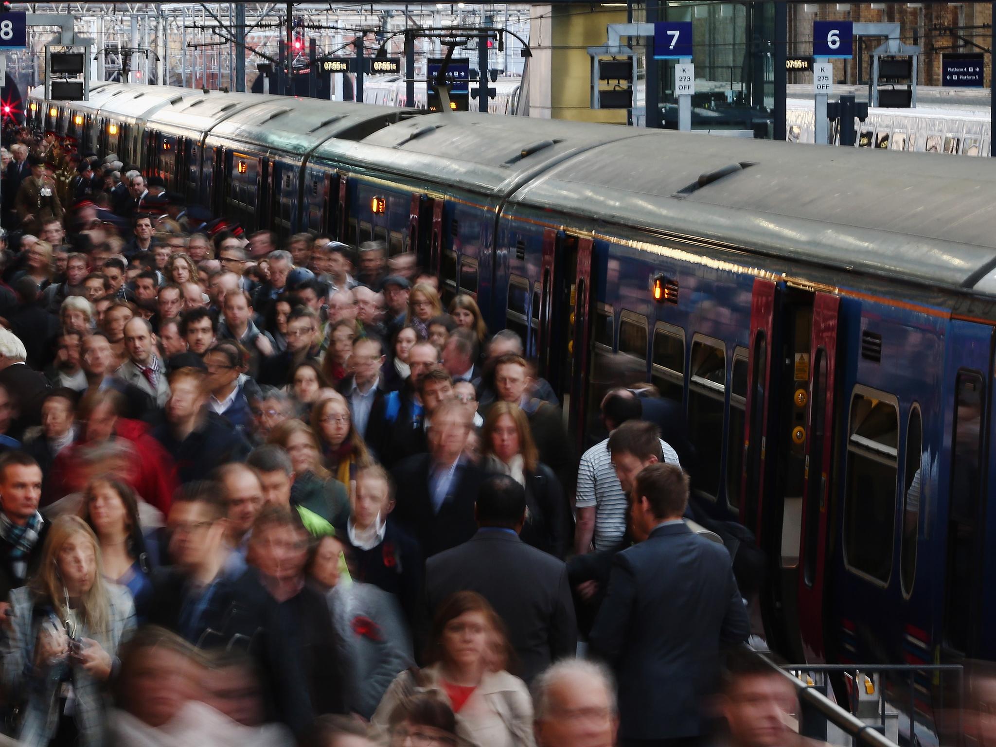 Passengers disembark a train at King's Cross station on November 7, 2014 in London, England