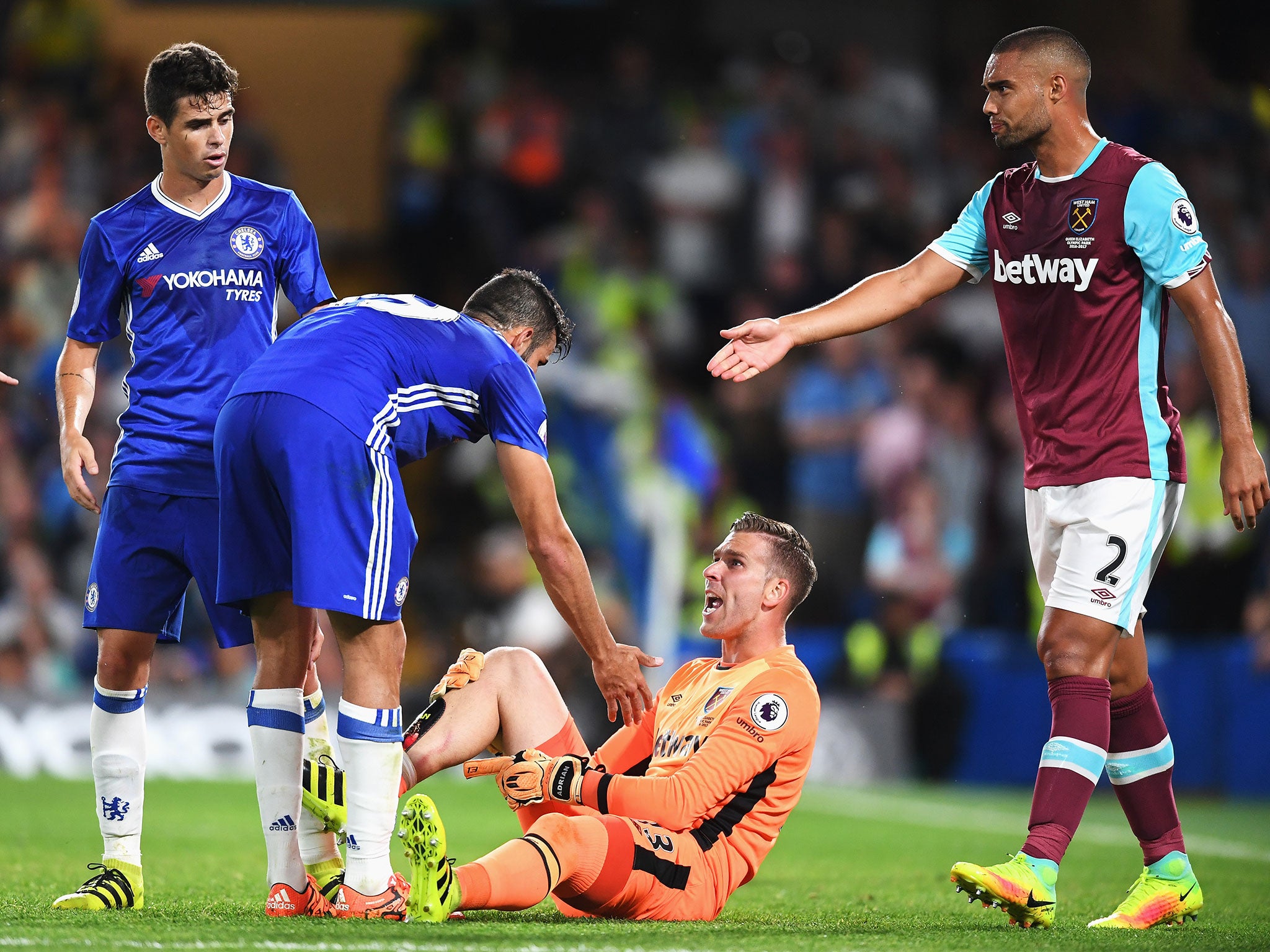 Diego Costa attempts to apologise to Adrian after his late challenge on the West Ham keeper