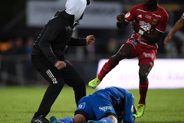 Ostersunds goalkeeper Aly Keita lies on the floor after being attacked