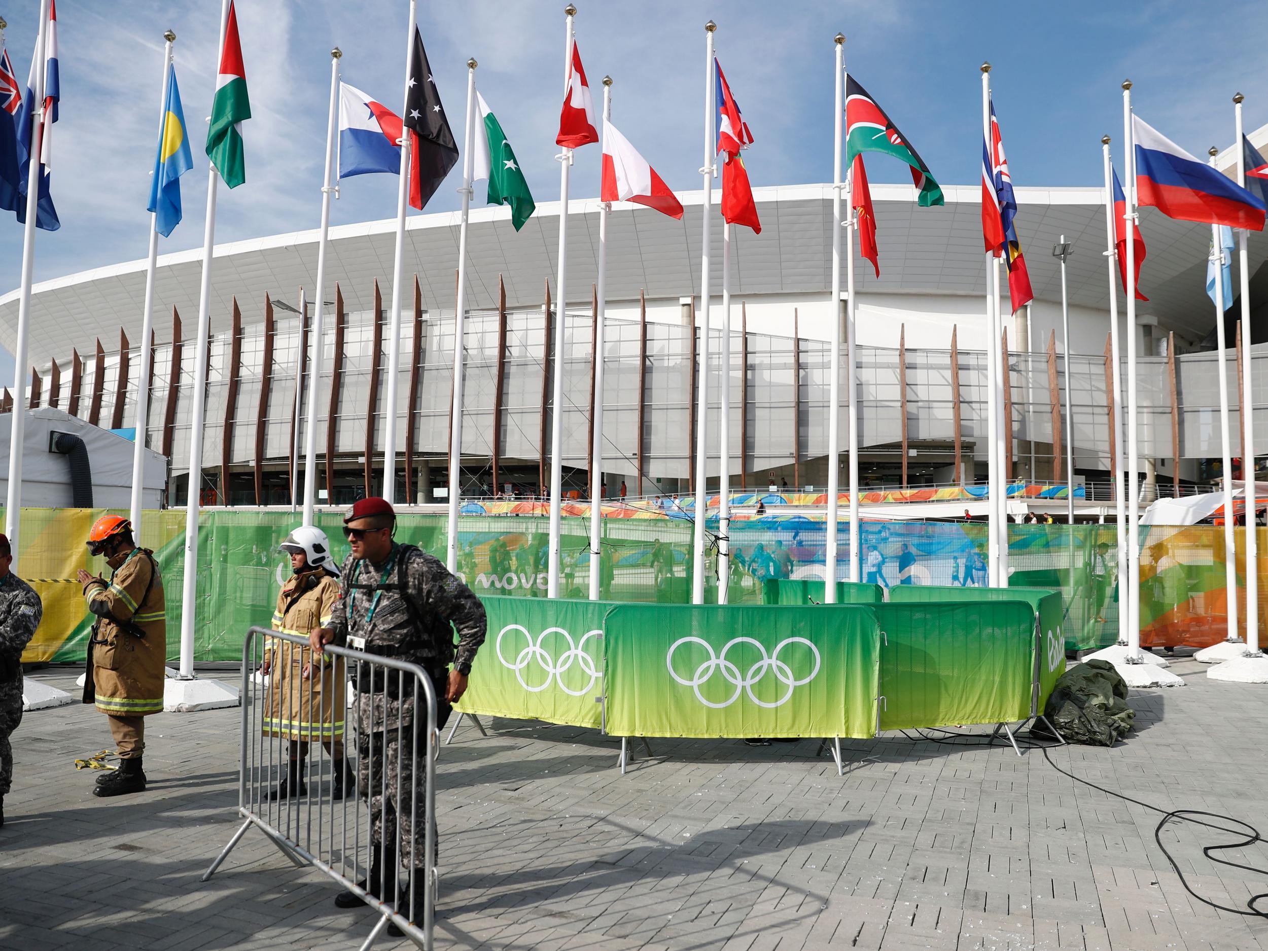 &#13;
Members of the military stand guard by a television camera that fell to the ground in the Olympic park &#13;