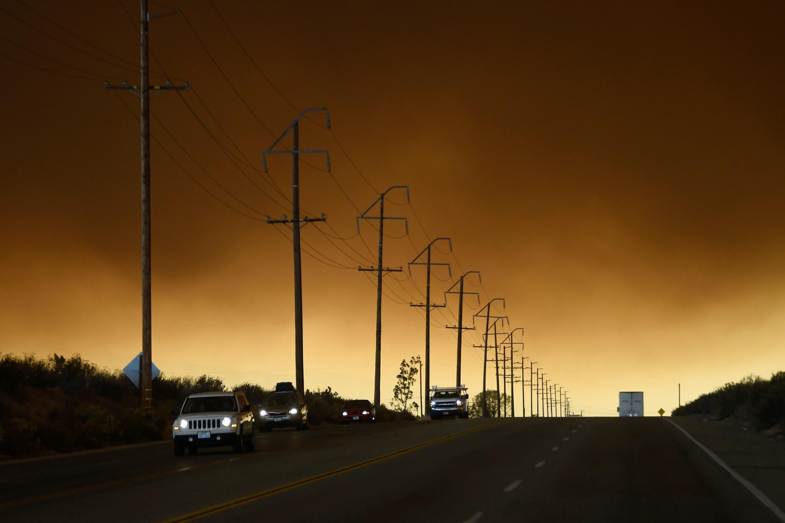 &#13;
Thick smoke fills the sky as residents leave their homes &#13;