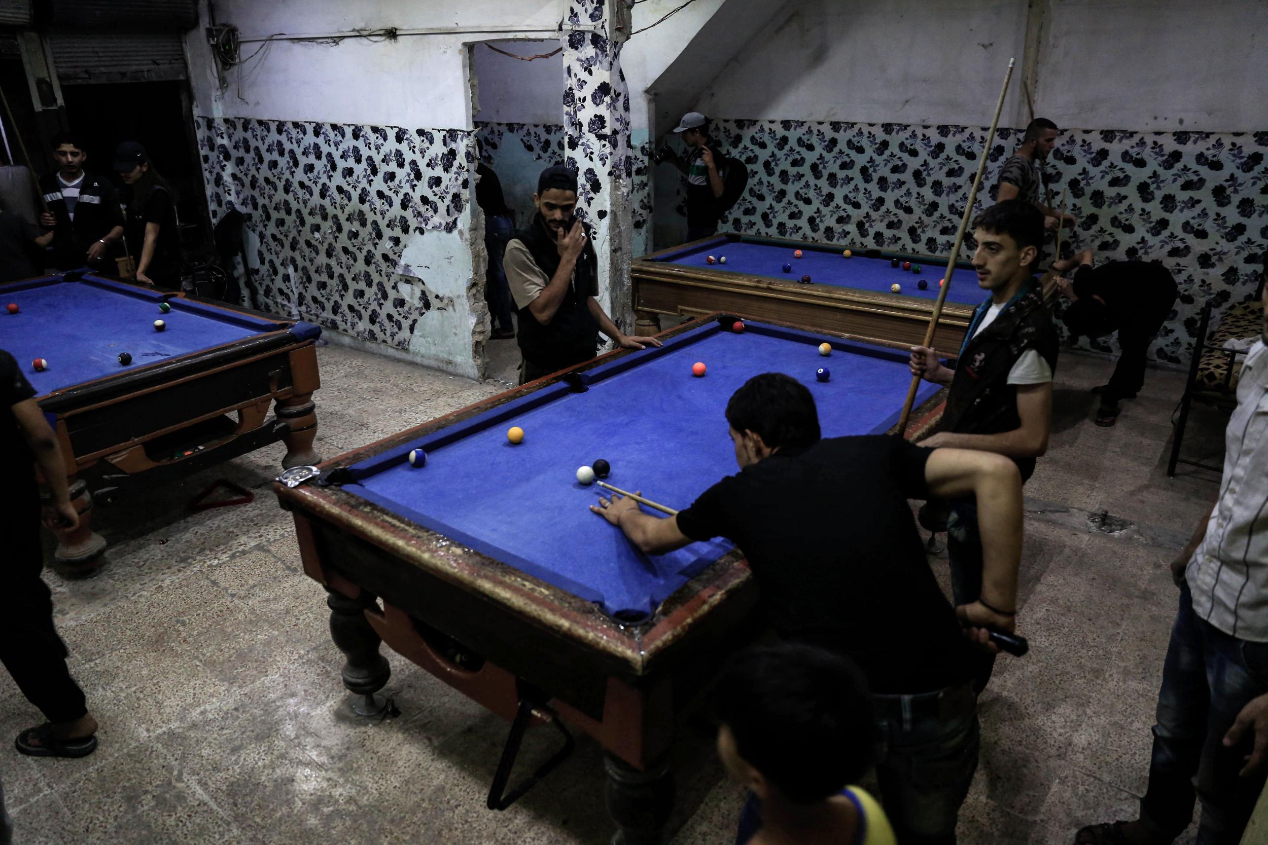 Syrians play pool at a games club in Syria's capital Damascus, rated the "least liveable" city in the world