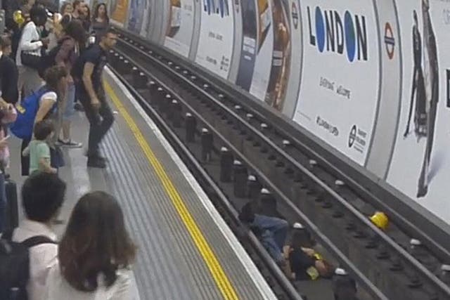 A man jumps onto tube tracks at Tottenham Court Road to pull a fallen man to safety
