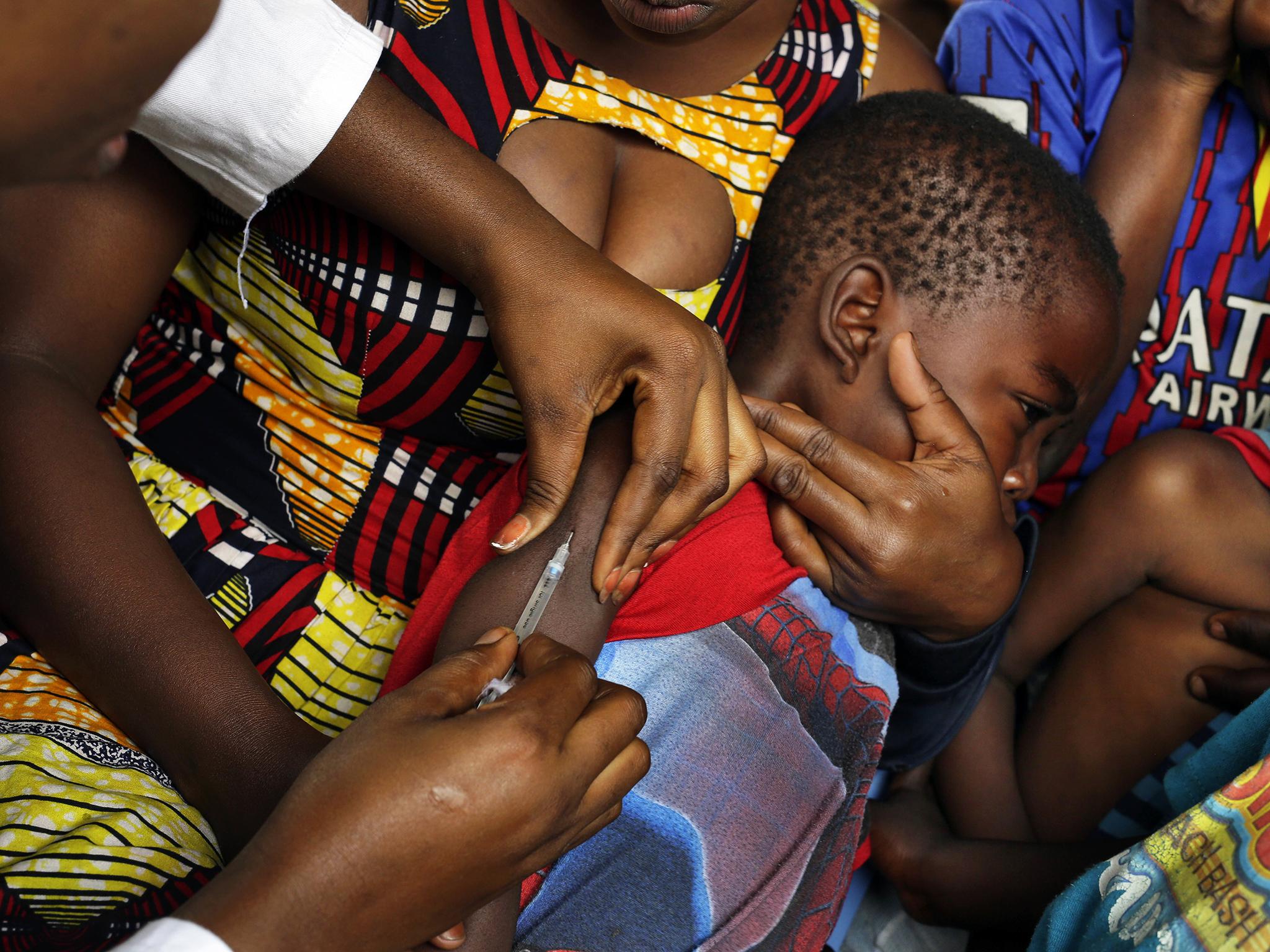A child in Kinshasa receives a vaccine against yellow fever after dozens of organisations launched emergency vaccination campaigns