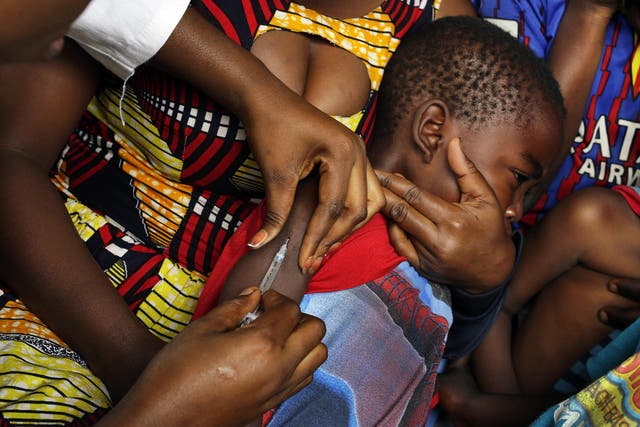 A child in Kinshasa receives a vaccine against yellow fever after dozens of organisations launched emergency vaccination campaigns