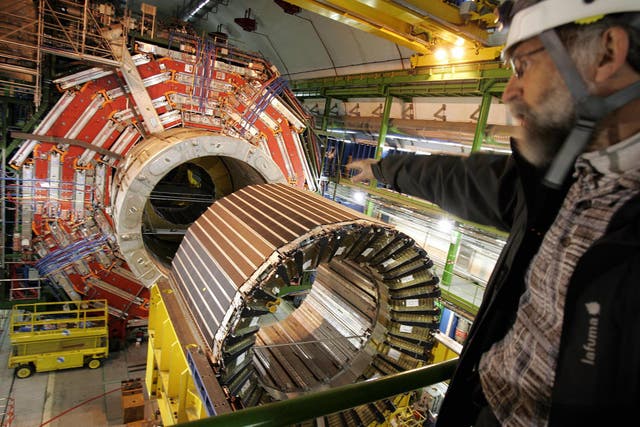 A engineer faces, 22 Mars 2007, near Geneva, the magnet core of the world's largest superconducting solenoid magnet (CMS, Compact Muon Solenoid), one of the experiments preparing to take data at European Organization for Nuclear Research (CERN)'s Large Hadron Collider