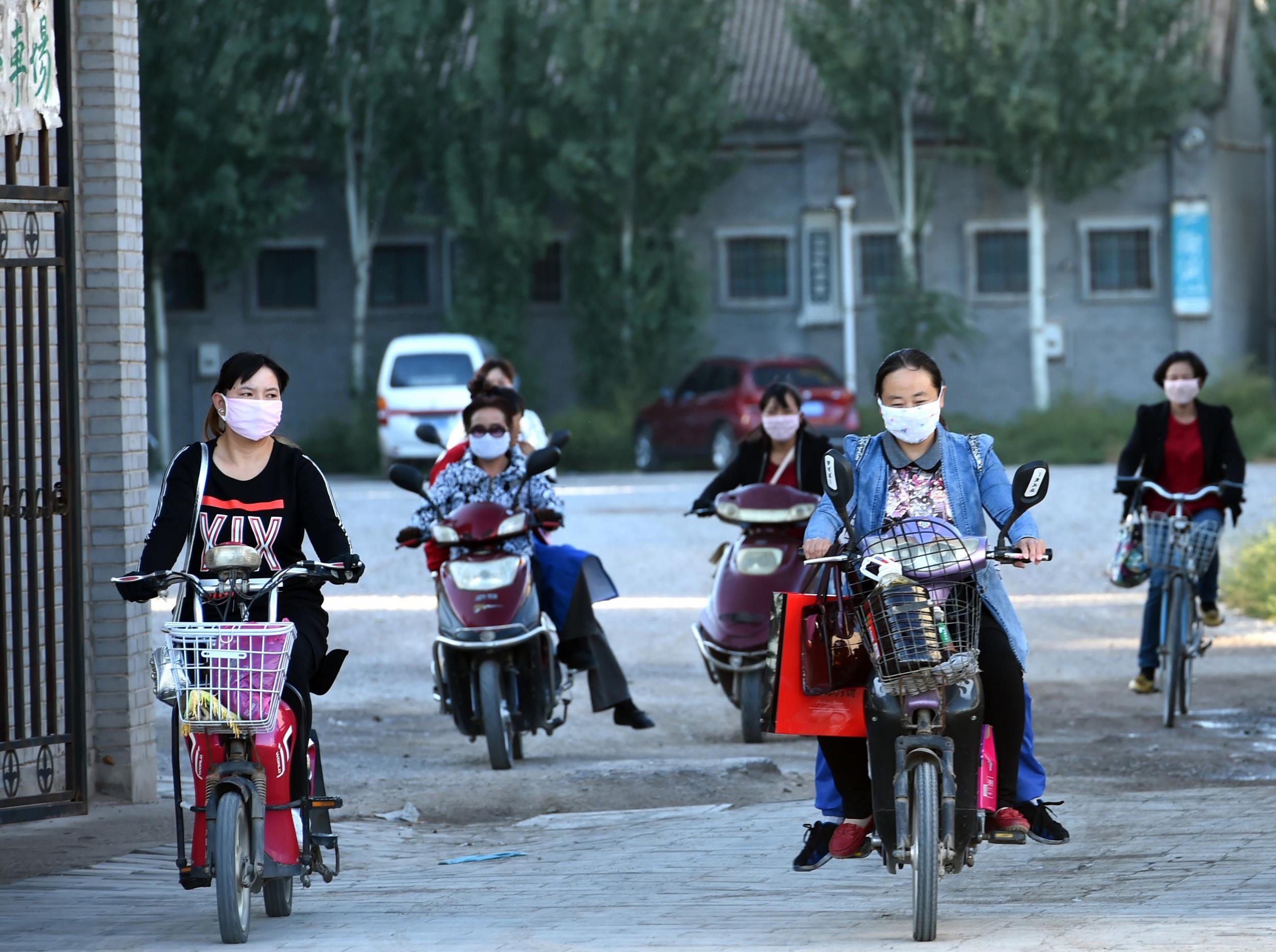 A group of women leaving work at a factory in Yinchuan, in north China's Ningxia province