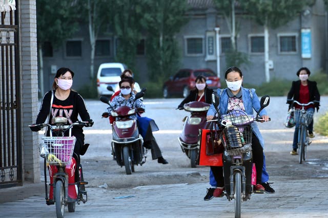A group of women leaving work at a factory in Yinchuan, in north China's Ningxia province