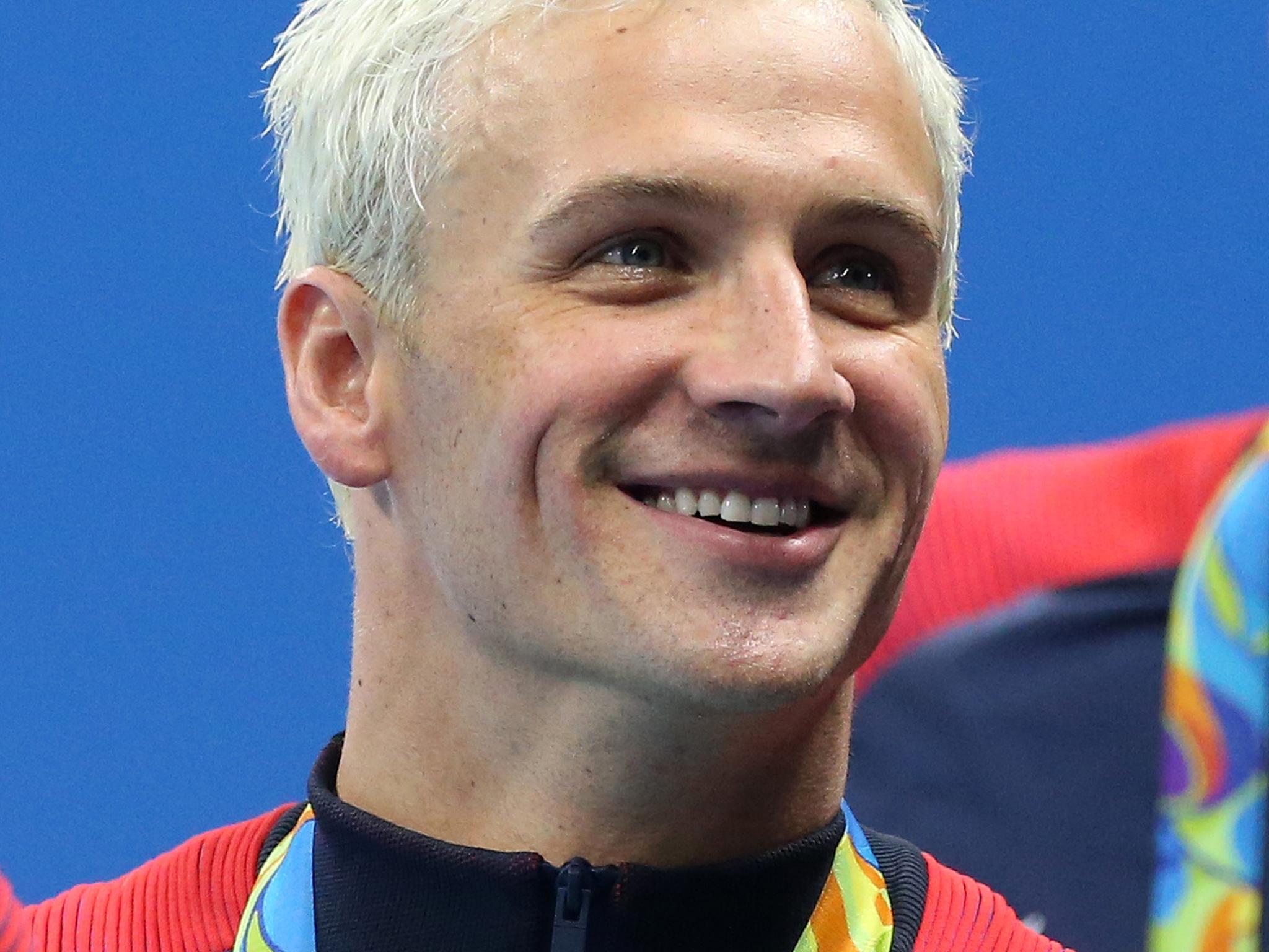 Ryan Lochte of Team USA celebrates winning the gold medal during the medal ceremony of the men's 200m freestyle relay on day 4 of the Rio 2016 Olympic Games at Olympic Aquatics Stadium