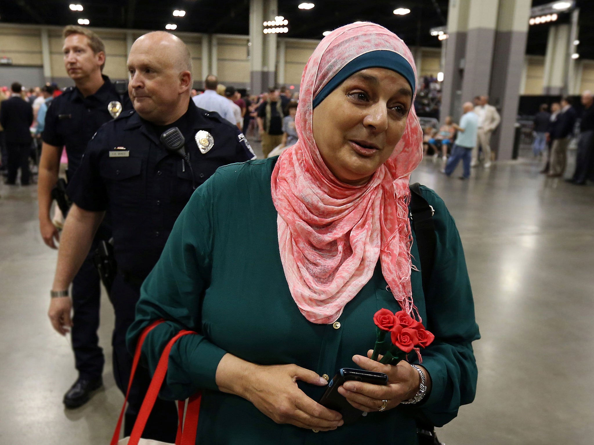 Police escort Rose Hamid out of Donald Trump's campaign rally in Charlotte, North Carolina, on 18 August 2016