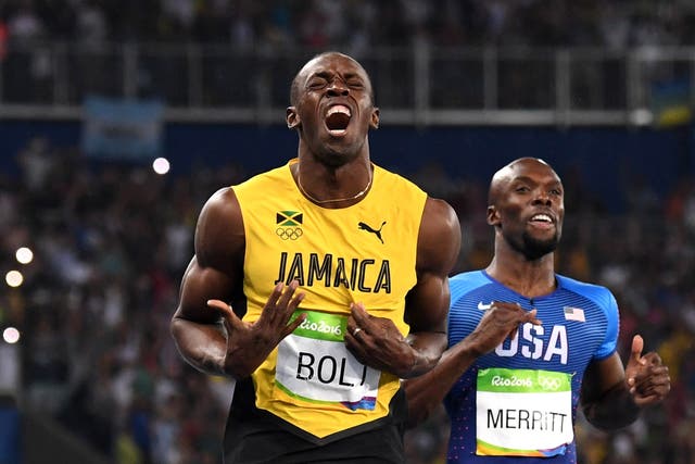Usain Bolt reacts as he crosses the finish line to win 200m Olympic gold