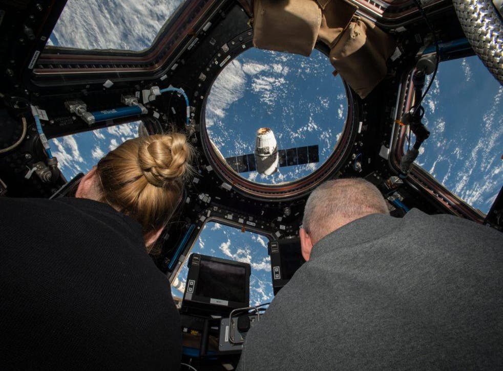 Kate Rubins (L) and Jeff Williams (R) preparing to grapple the SpaceX Dragon supply spacecraft from aboard the ISS