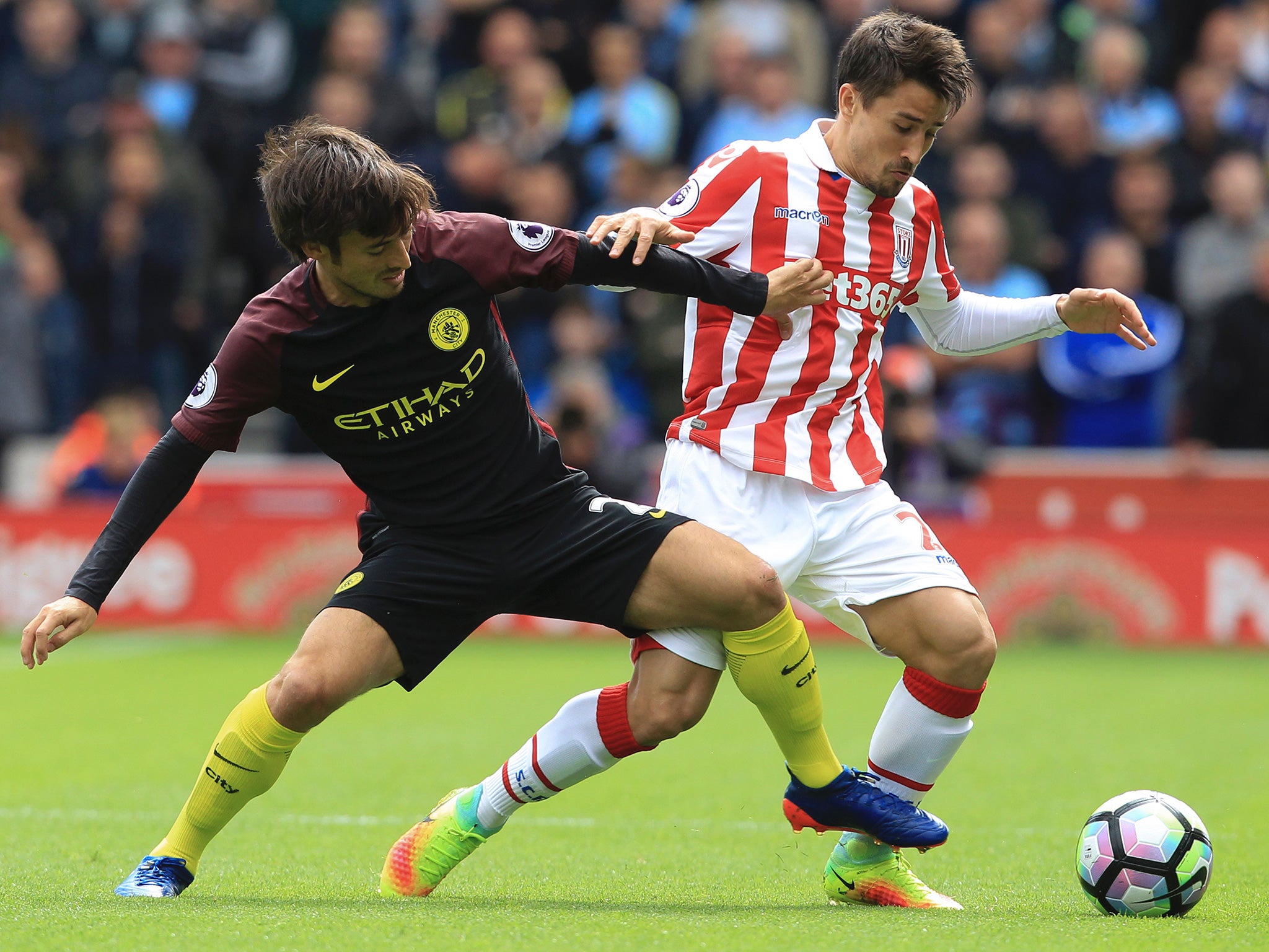 Silva and Bojan battle for the ball at the bet365 Stadium
