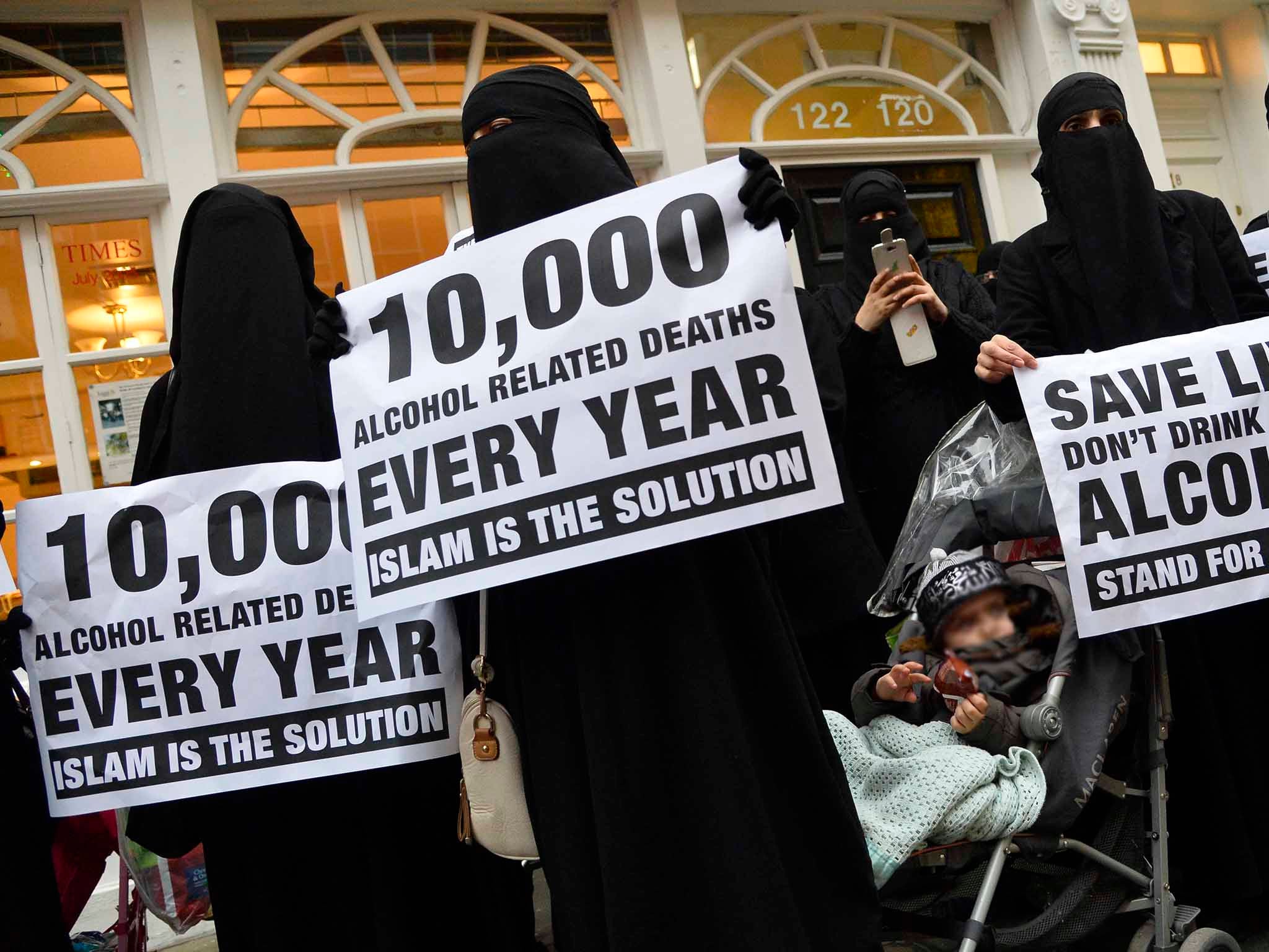 Women hold placards during a march and rally in east London December 13, 2013. They were participating in a rally organised by British Islamist Anjem Choudary condemning use of alcohol and promoting Shariah law (Reuters)