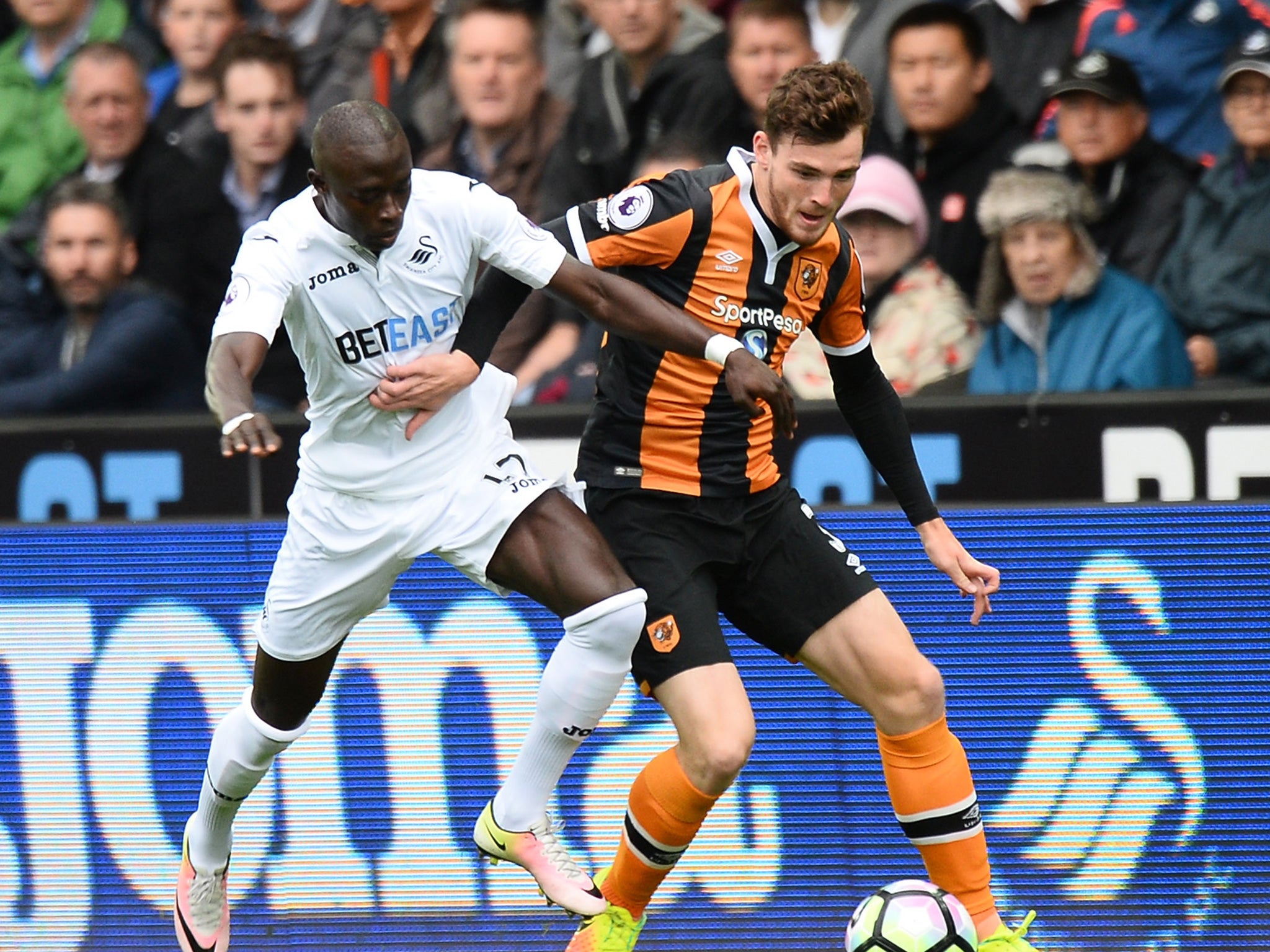 Madou Barrow battles for the ball with Andrew Robertson