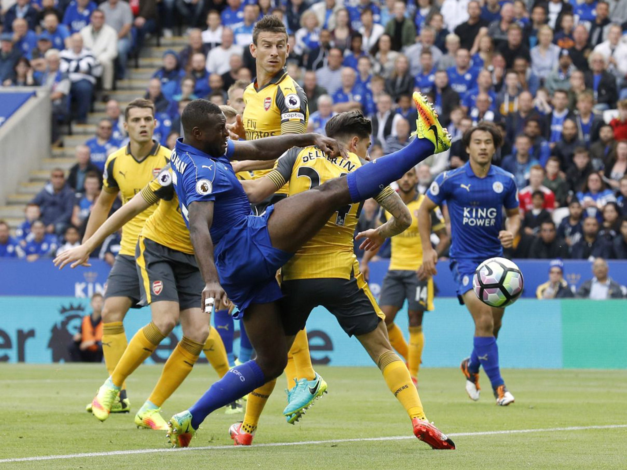 Laurent Koscielny looks on as Wes Morgan fails to make contact with the ball in front of the Arsenal goal