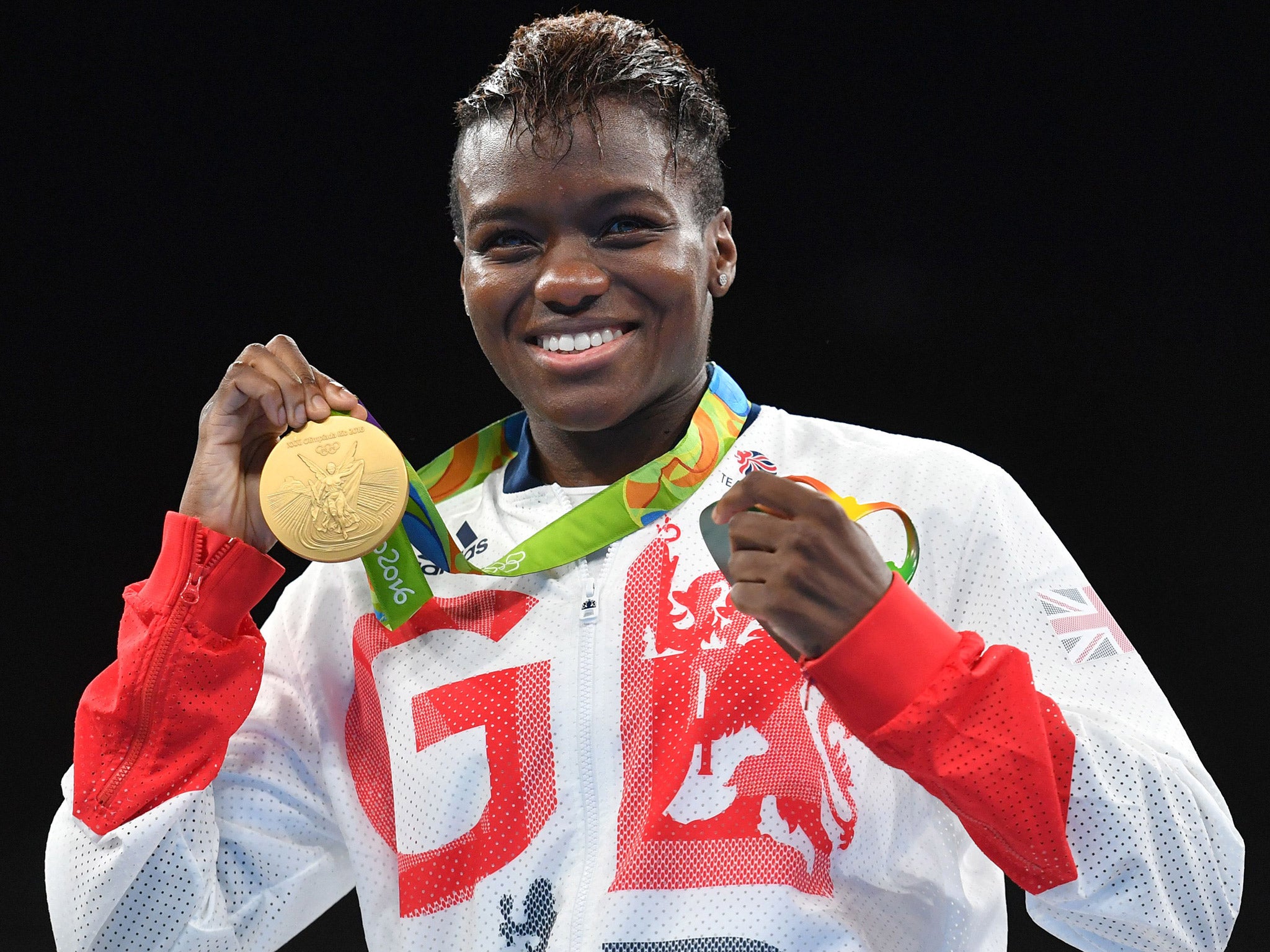 Nicola Adams celebrates with her gold medal after winning the women's flyweight final