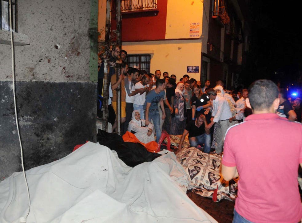 People react after an explosion at a wedding in Gaziantep, southeastern Turke