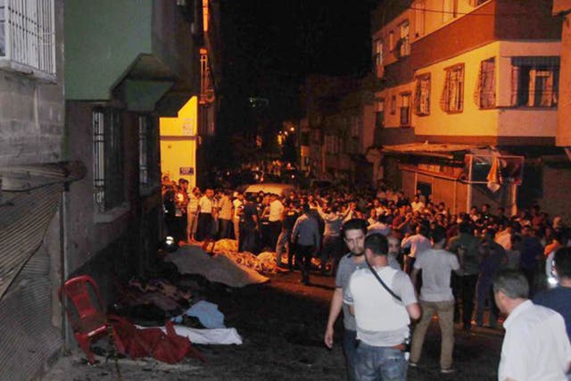 People help the wounded last night in Gaziantep after a suicide bomber targeted a wedding