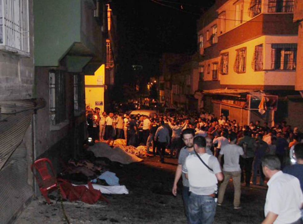 People help the wounded last night in Gaziantep after a suicide bomber targeted a wedding